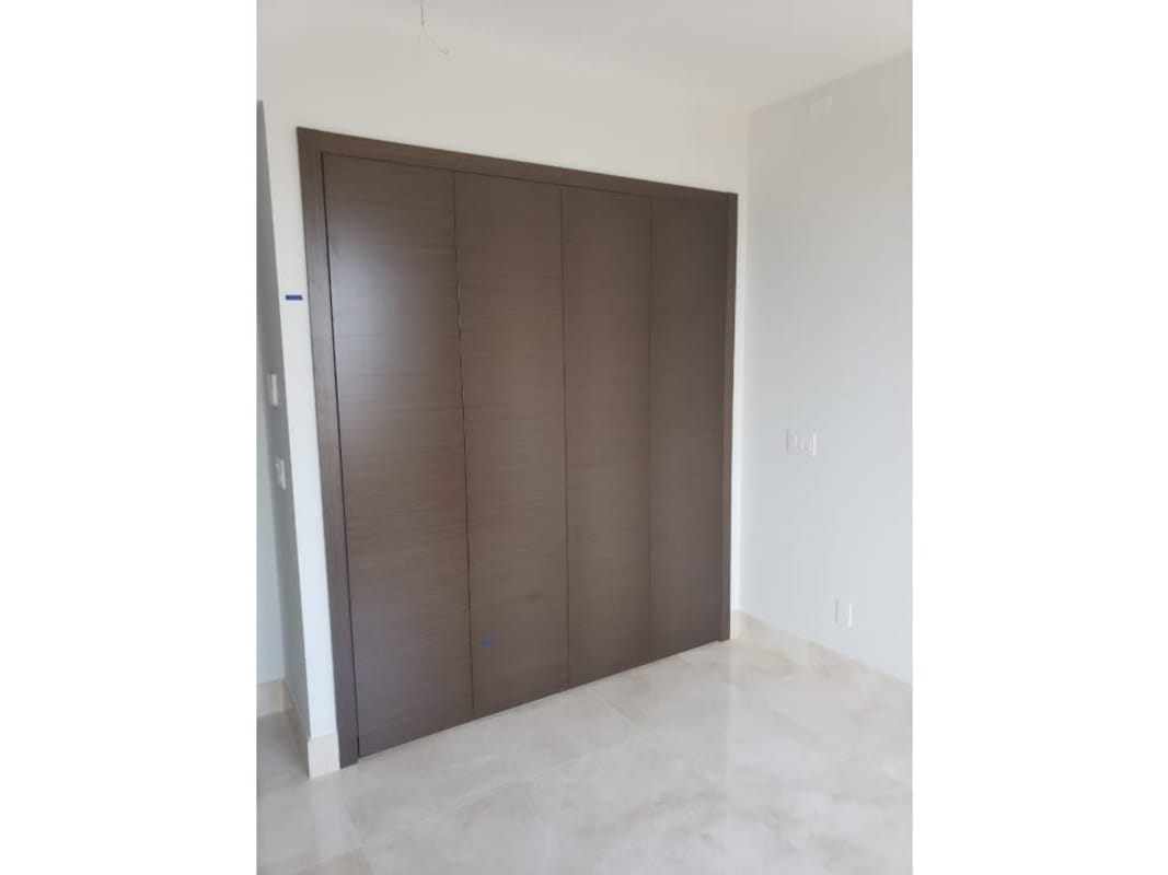 Spacious walk-in closet with custom cabinetry in PH Green Garden Santa María Panama