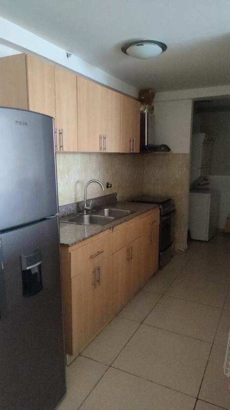 Modern kitchen with granite counter, wood cabinetry, and appliances PH Terrazas del Rey Panama