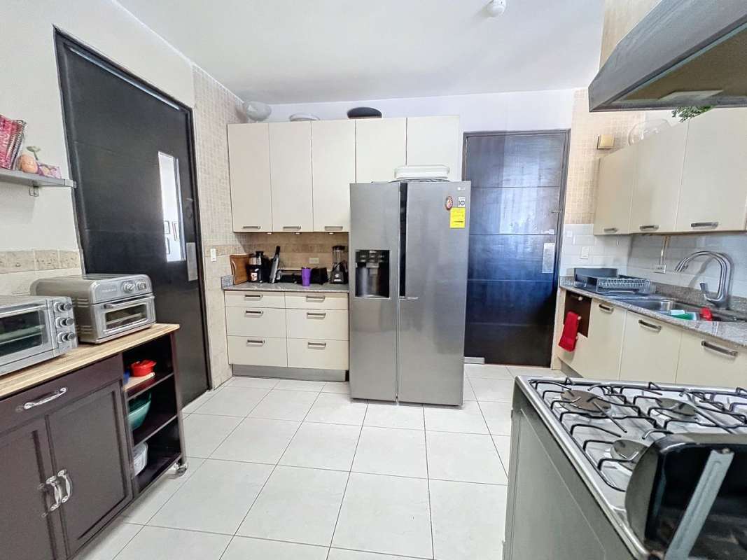 Modern kitchen with granite countertops, stainless appliances at PH Bella Vista Park Panama City