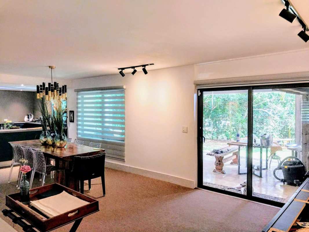 Elegant dining room with large glass doors to terrace in renovated Clayton house rental