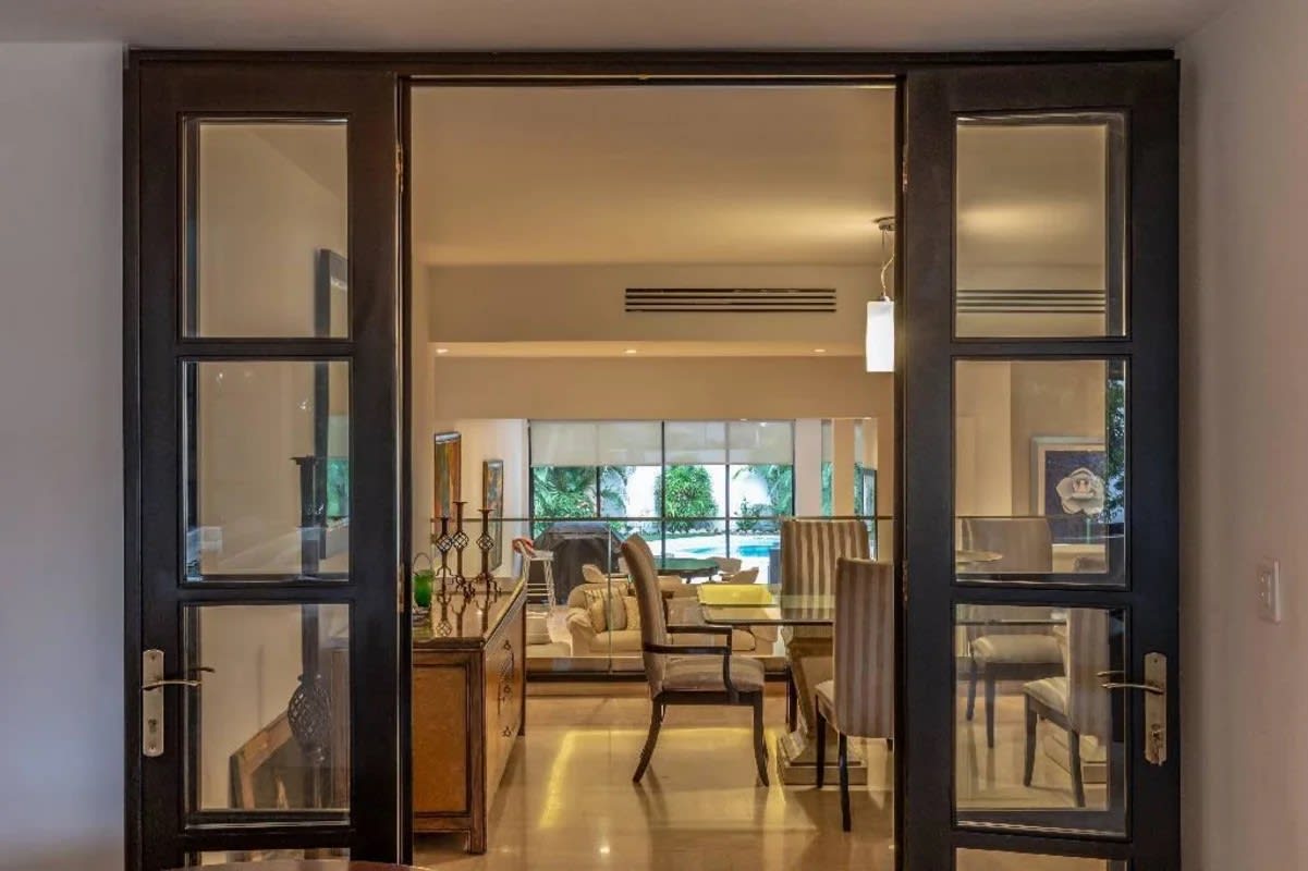 Modern spacious kitchen with granite countertops and white cabinets in duplex house Obarrio Panama City