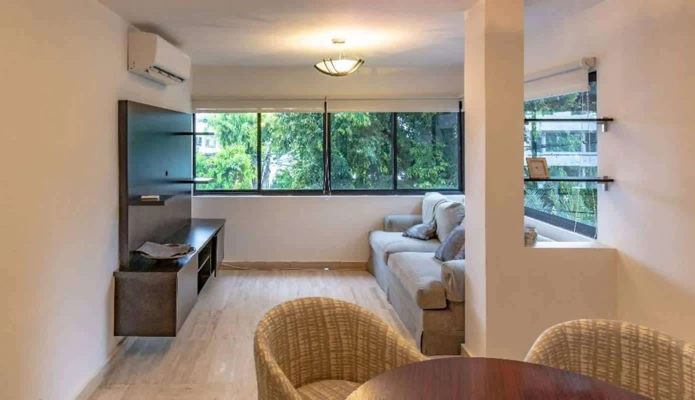 Cozy living dining space with large windows and neutral design in Obarrio Panama