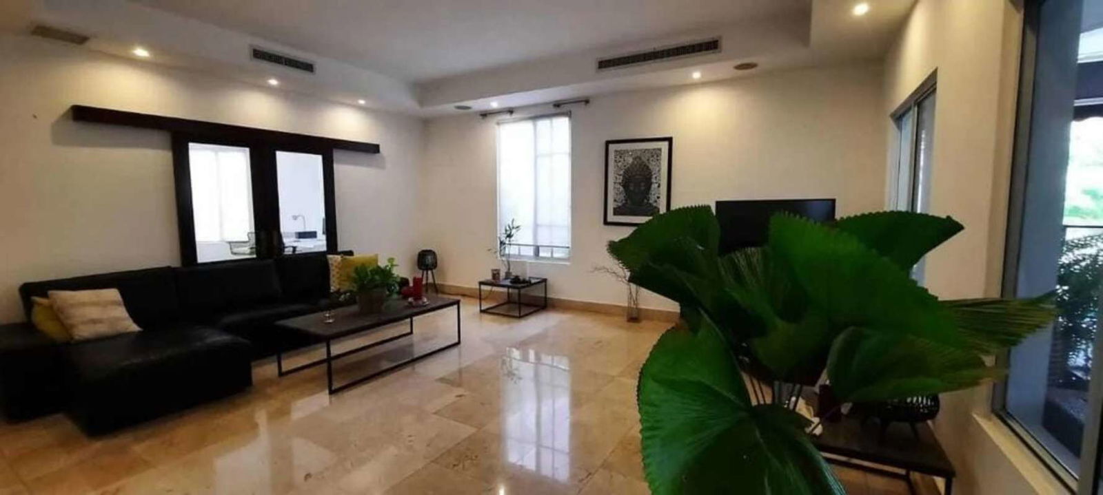 Bright living area with marble floors and garden views in luxury home Costa del Este Panama