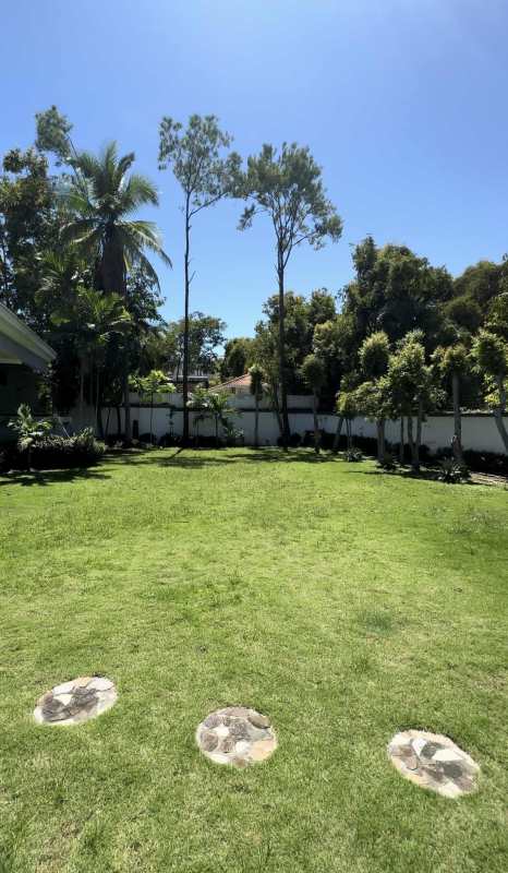 Large backyard green lawn tropical landscaping private house Panama