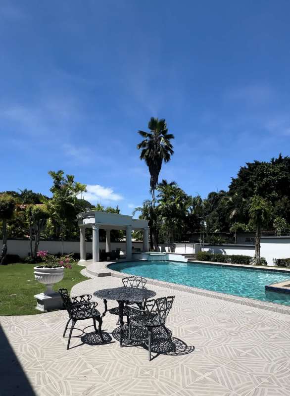 Mediterranean design backyard featuring swimming pool, jacuzzi, palm trees Altos del Golf Panama