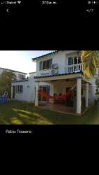 Landscaped beach pathway lined with palms and purple flowers leading to Sea Club and spa facilities in Playa Blanca