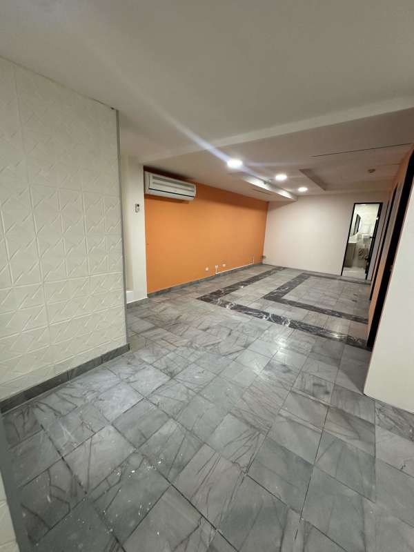 Office rental in PH BAC Tower on Avenida Balboa with marble tile floor orange accent walls and recessed lights