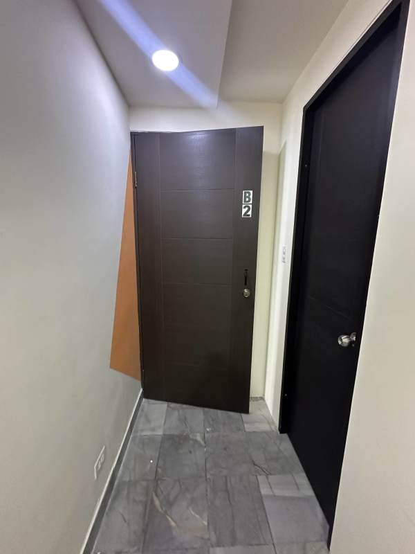 Bright office interior with marble flooring orange accent wall AC unit and recessed lights in PH BAC Tower