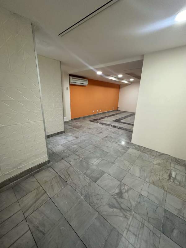 Modern reception lobby inside PH BAC Tower with wood desk marble tile and flower vase Panama City