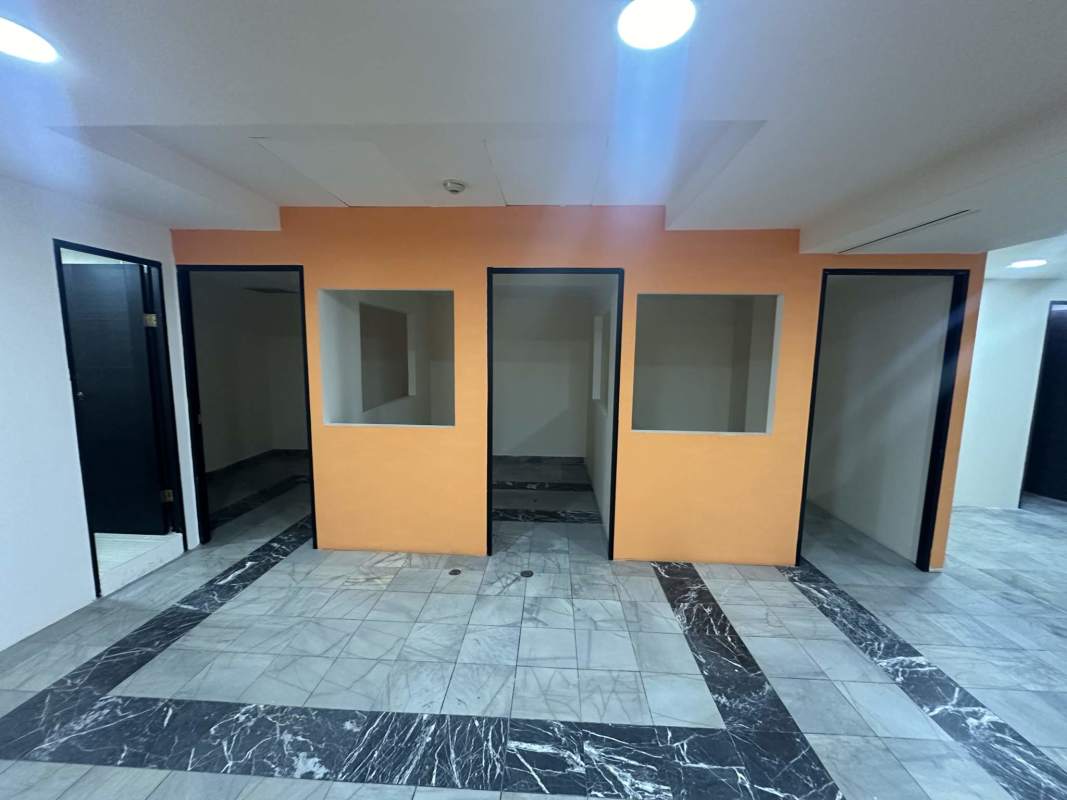 Office space with several partitioned rooms peach accent wall and marble flooring PH BAC Tower Panama City