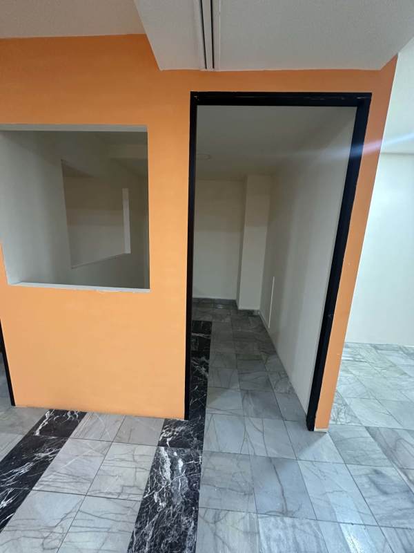 Commercial workspace with peach wall accent door and marble flooring inside PH BAC Tower Panama City