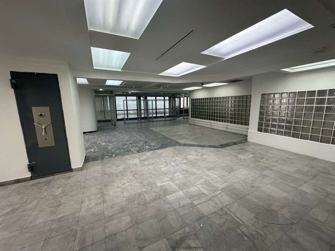 Sophisticated commercial lobby entrance with security vault door at Torre BAC Panama City