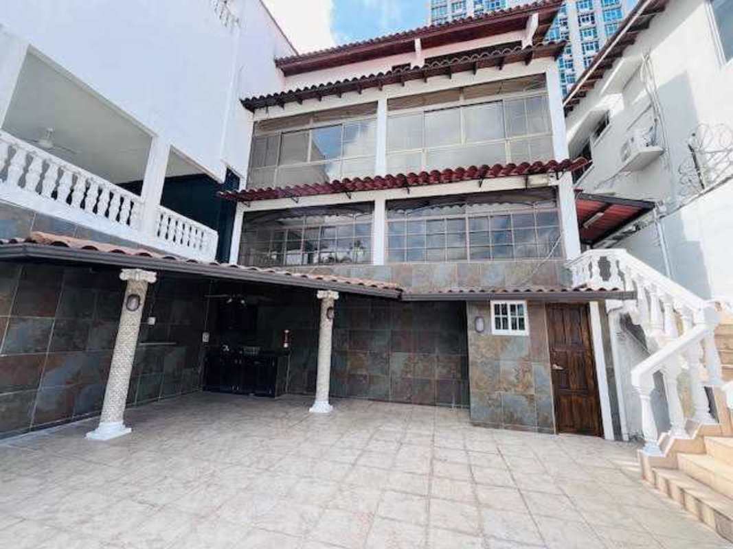 Mediterranean house exterior in La Alameda with balconies, courtyard, and garden