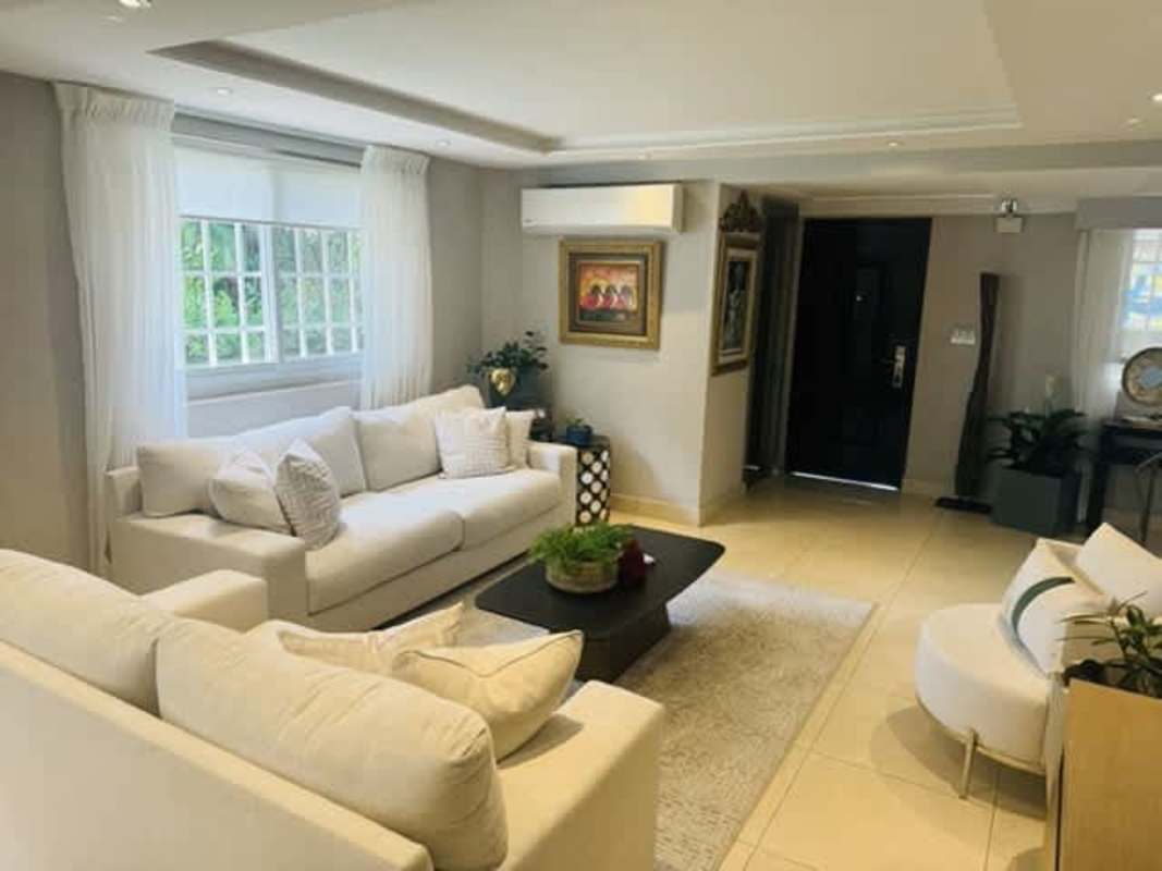 Modern kitchen with appliances and breakfast bar in duplex for rent in Cardenas Clayton near Ciudad del Saber Panama