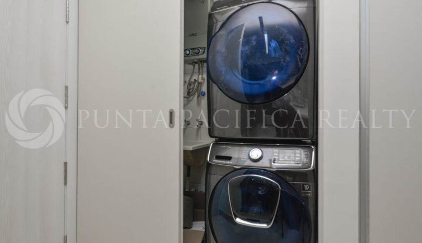 Open plan kitchen with quartz counters, light cabinetry, stainless steel appliances PH Coco Place Coco del Mar