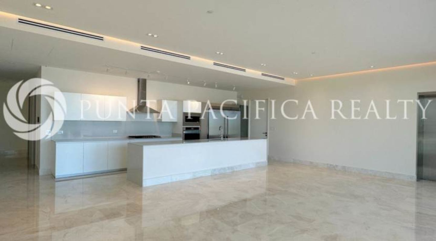 Modern kitchen with island, white cabinetry, marble flooring, stainless appliances in Ocean Reef Islands Panama apartment