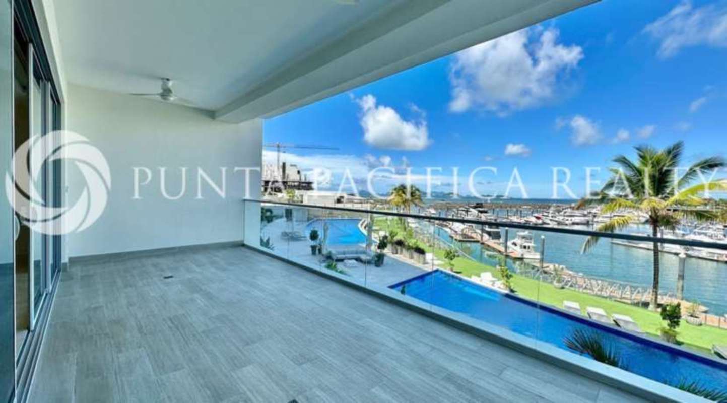 Minimalist bathroom with pedestal sink, beige stone tiles, modern fittings at Beach Club Residences Panama