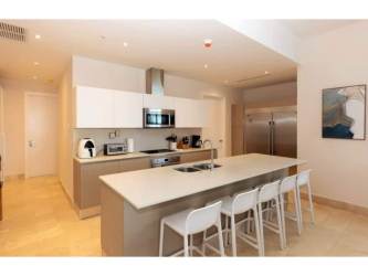 Contemporary kitchen with large island and built-in stainless appliances in Marina Village condo Panama