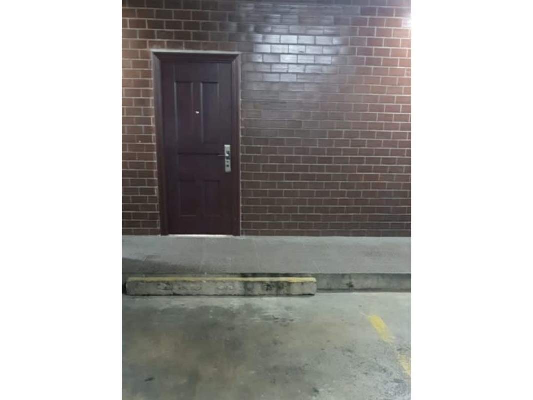 Back entrance to Plaza San Fernando with parking spaces and access doors Panama City