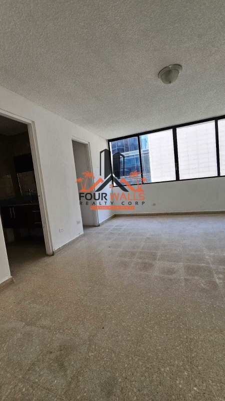 Bright kitchen with orange cabinets, black countertops, large window, PH Monaco Obarrio Panama