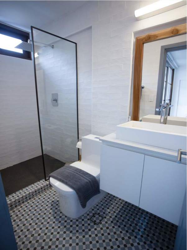 Minimalist bathroom with glass shower, tile details in PH Plaza Santa Ana Casco Viejo Panama City