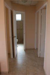 Minimalist white kitchen with cabinets and tile in Arraiján Panama