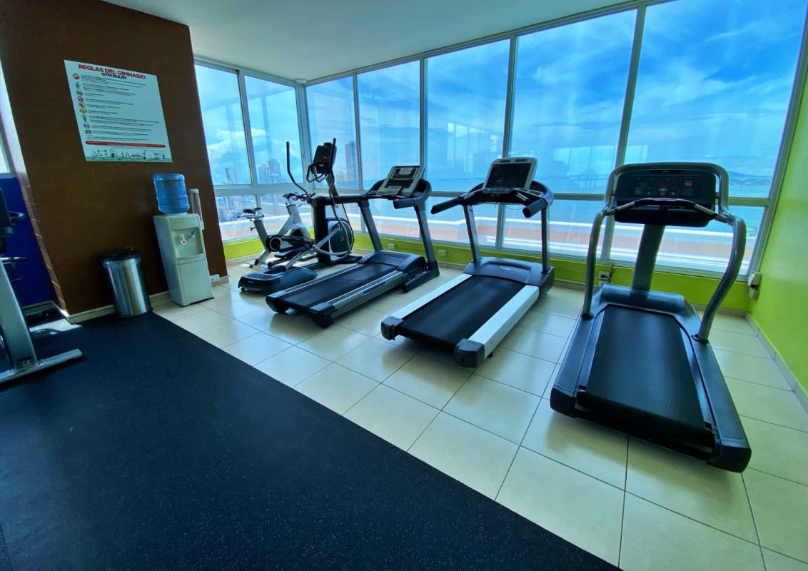 Fully equipped gym with panoramic windows ocean and skyline view in PH Vista del Mar Panama