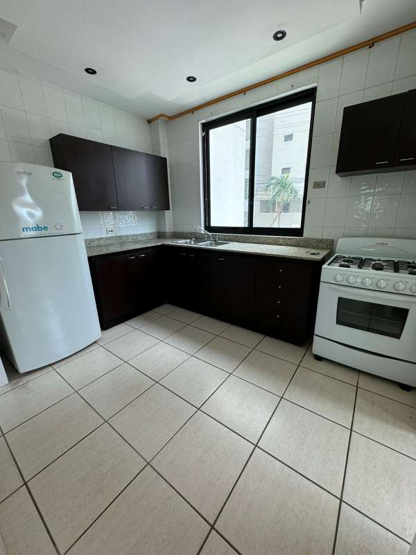 Kitchen with granite countertops, tile backsplash, large window in PH Green Pacific Panama City