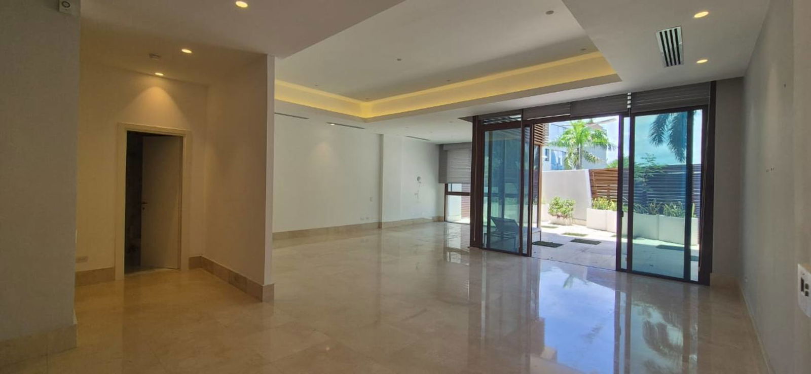 Large floor-to-ceiling windows in modern apartment overlooking marina Ocean Reef Islands