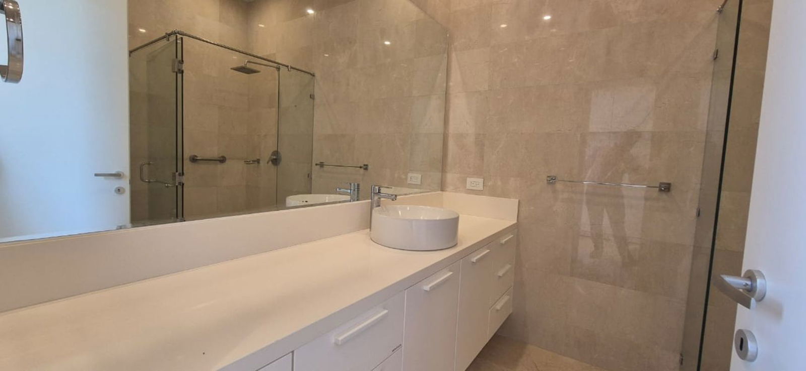 Elegant marble bathroom with vessel sink and glass shower in Ocean Reef Islands apartment