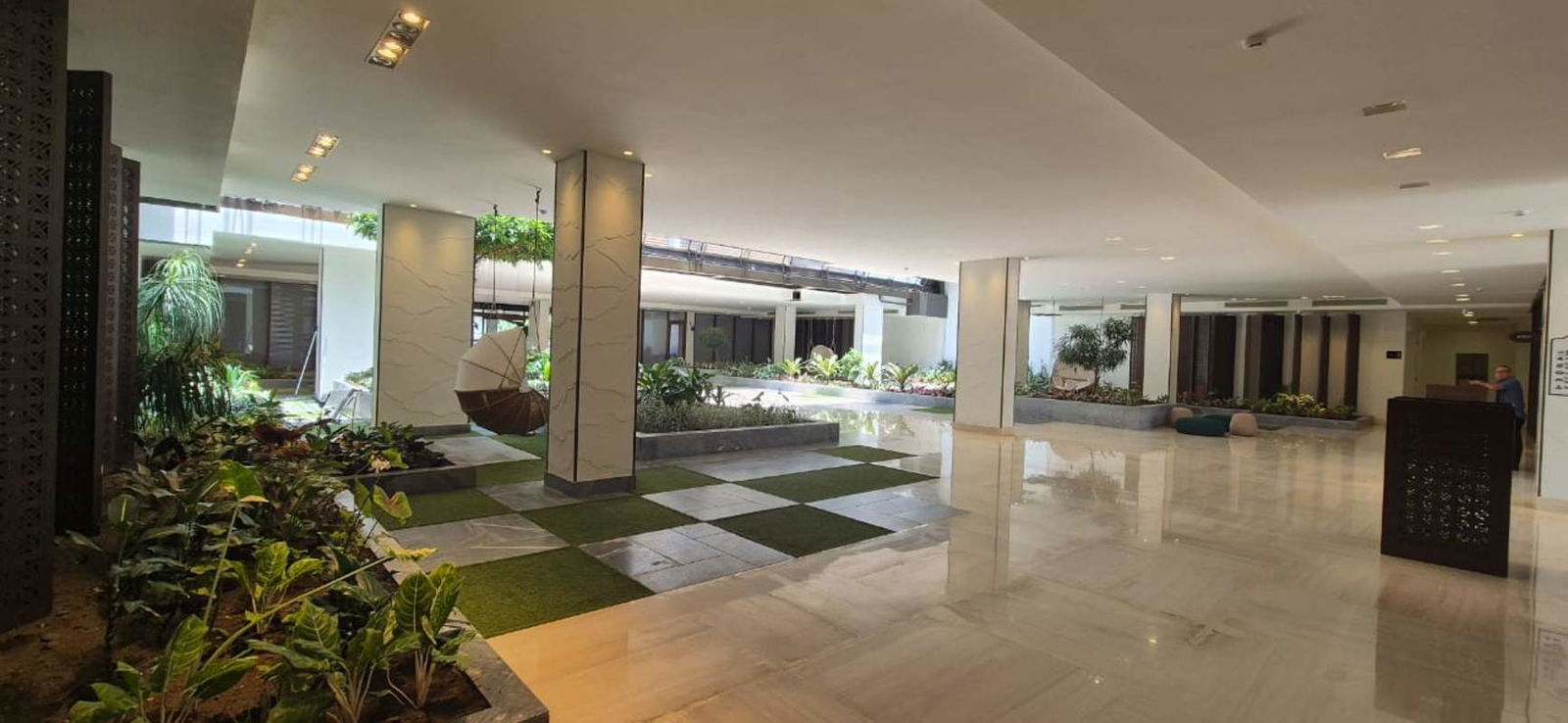Contemporary lobby at Ocean Reef with indoor garden, marble floors and seating area