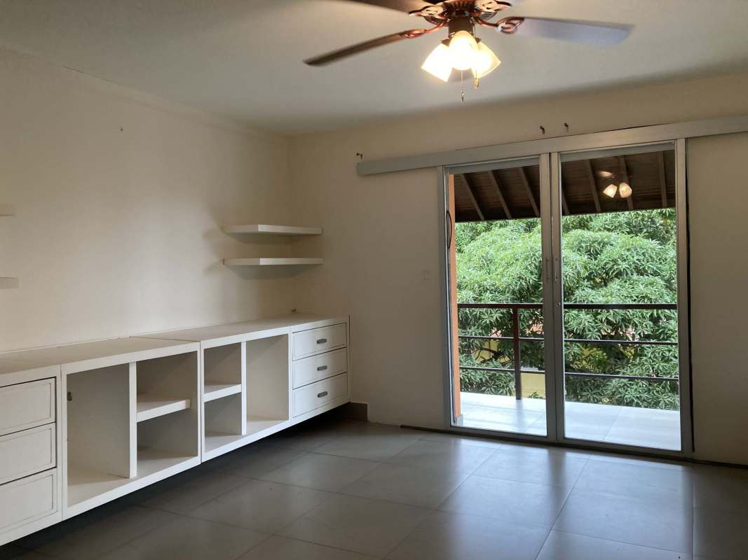 Spacious living room with large windows, tile floors, garden access in Clayton duplex