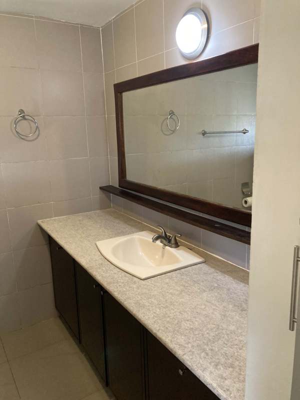 Open kitchen with granite countertops, wood cabinets, stainless appliances in Clayton home