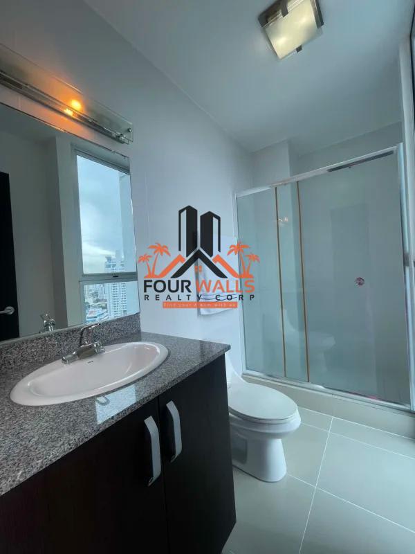 Contemporary furnished living and dining in PH Waterfalls with red chairs, modern art, panoramic windows