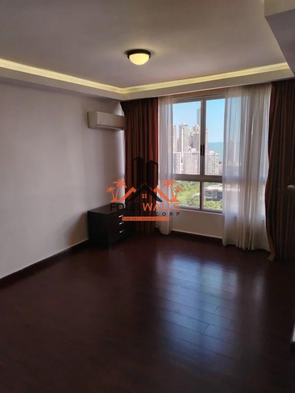 Modern living space with large windows, tile flooring, open plan layout in PH Pacific Coast