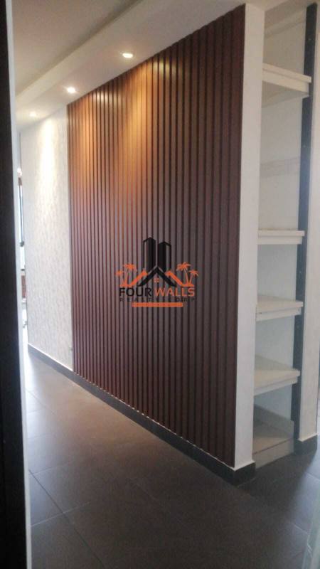 Hallway with wooden slats accent wall and ceiling lights PH Pacific Coast Panama