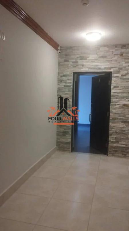 Spacious hallway with stone accent wall and tiled floors PH Pacific Coast San Francisco