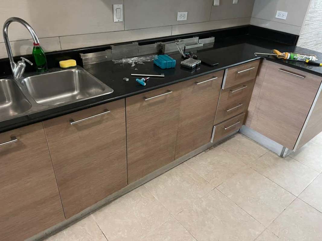 Kitchen with granite counters, light wood cabinets, double stainless sink in Pacific Village Punta Pacifica