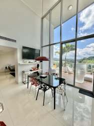 Modern living room with double-height ceiling and large windows in PH Mosaic Panama Pacifico