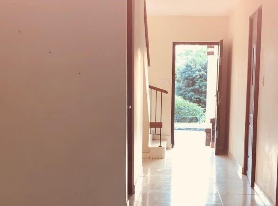 Entryway and staircase with large window and tiled floors in house at Mirador del Lago Las Cumbres Panama