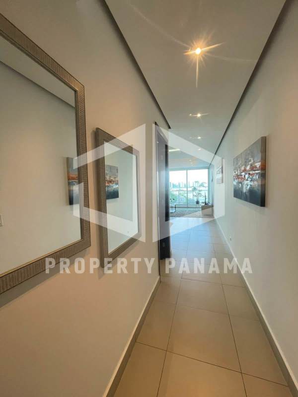 Modern open-plan apartment living space with large windows overlooking Pacific Ocean in Punta Pacifica Panama