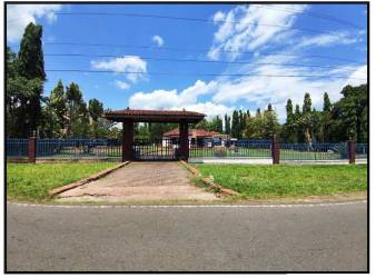 Secure gated country estate entrance with landscaped garden shaded gate in Bugaba Chiriquí Panama