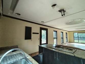 Spacious open kitchen with granite countertops double sink large windows countryside house Bugaba Panama
