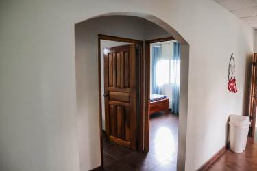 Bedroom with ceramic floors ceiling fan and large window house in Pedasí Panama