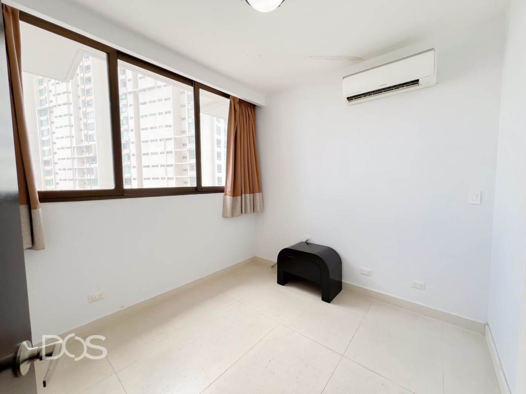 Spacious bedroom featuring large window with city view and AC unit in PH Costamare