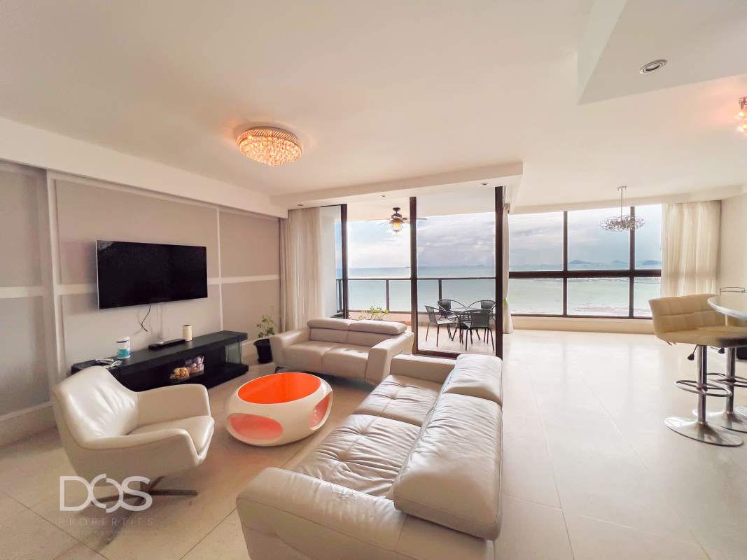 Modern spacious living room with large windows and balcony facing Pacific Ocean at PH Costamare Panama City
