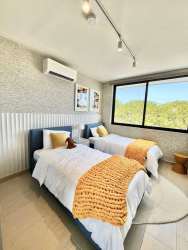 Bright second floor bedrooms in PH Imaterra Panama Pacifico house with large windows