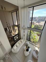 Master bedroom with large windows and neutral tones PH Imaterra Panama Pacifico