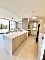 Modern kitchen with white island and wood cabinetry PH Imaterra Panama Pacifico