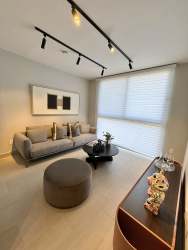 Open concept dining and living area with natural lighting in PH Imaterra home Panama Pacifico